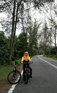 Man riding bicycle on road