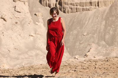 Young woman standing on sand