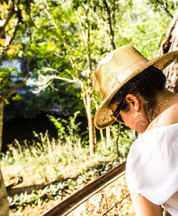 Midsection of man with hat on tree