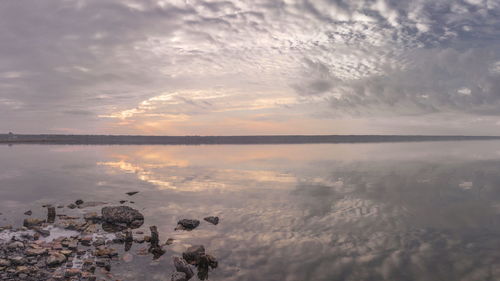 Scenic view of sea against sky at sunset