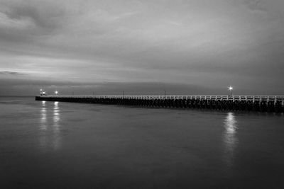 Pier over sea against sky