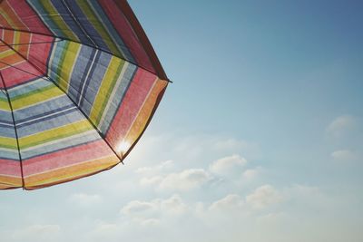 Low angle view of multi colored umbrellas against sky