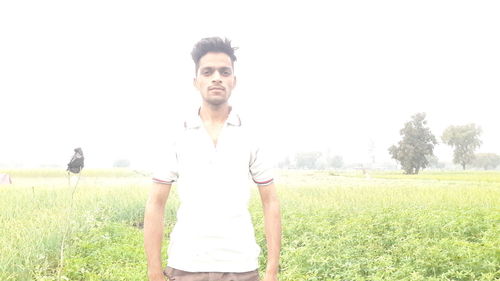 Portrait of smiling man standing on field