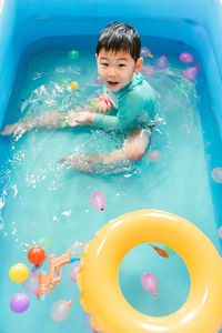 High angle view of boy swimming in sea