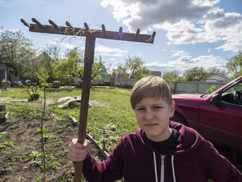 Portrait of boy on plants against sky