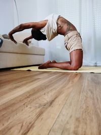 Full length of woman exercising on table