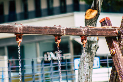 Close-up of old swing at park