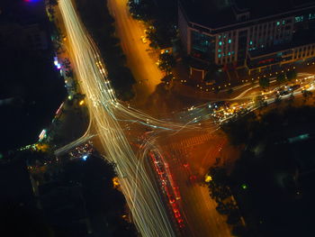 Aerial view of illuminated city street and buildings at night