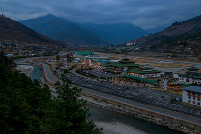 Aerial view of road by mountains against sky