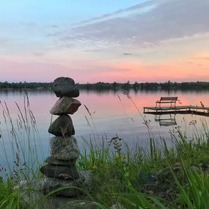 Scenic view of lake against sky during sunset
