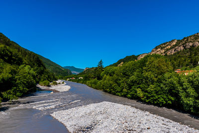 Scenic view of mountains against clear blue sky