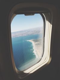 Scenic view of sea seen through airplane window