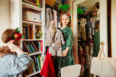 Portrait of smiling young woman standing in store