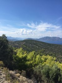 Scenic view of mountains against cloudy sky