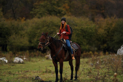 Man riding horse on field