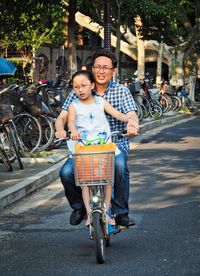 Portrait of smiling man riding bicycle on city