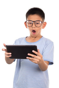 Boy holding mobile phone against white background