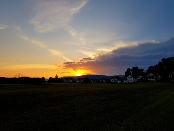 Scenic view of field against sky during sunset