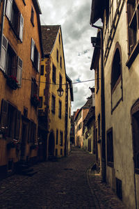 Narrow alley amidst buildings in city