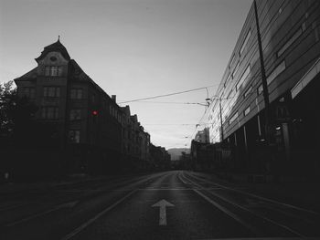 Empty road along buildings