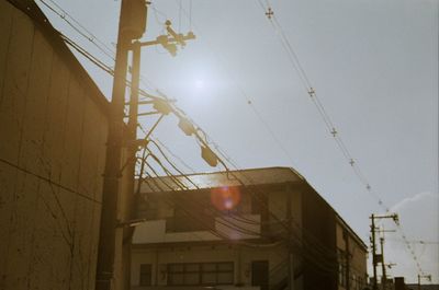 Low angle view of electricity pylon against sky