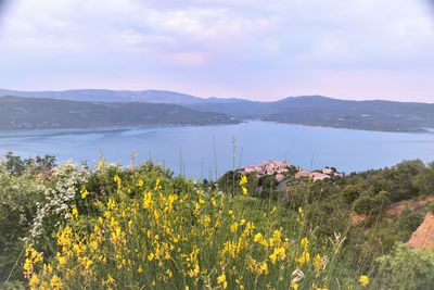 Scenic view of sea and mountains against sky