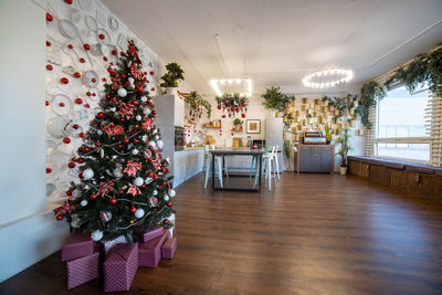 Kitchen decorated with pine garlands and christmas toys, no people