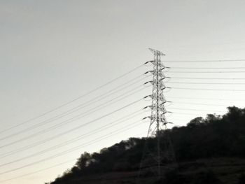 Low angle view of electricity pylon against sky