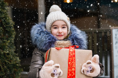 Portrait of smiling young woman in warm clothes