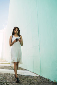 Full length of woman standing on wall