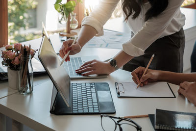 Midsection of business colleagues working at office