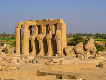 Statues at temple against clear sky