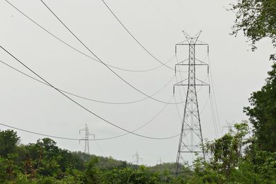 Low angle view of electricity pylon against sky