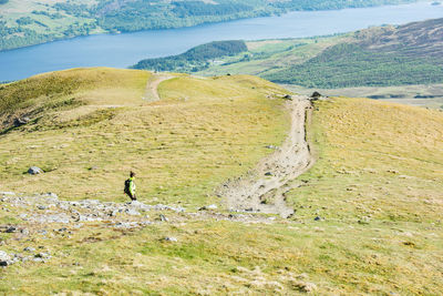 Young active female hiker descending into the valley from ben lawers peak