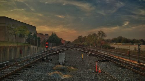 Railroad tracks against sky at night