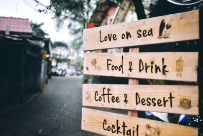 Close-up of information sign on street in city