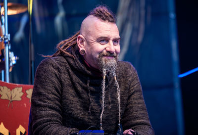 Portrait of smiling man sitting on floor