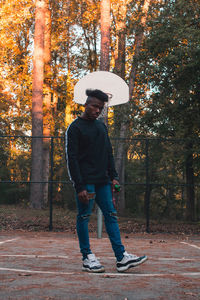 Full length of man standing by tree during autumn