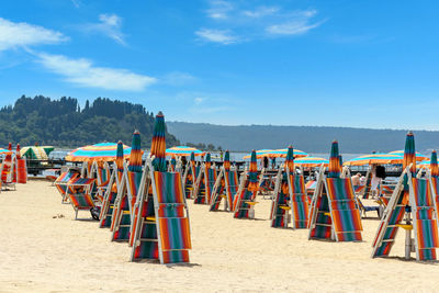 People at beach against sky