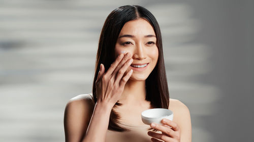 Portrait of young woman drinking glass