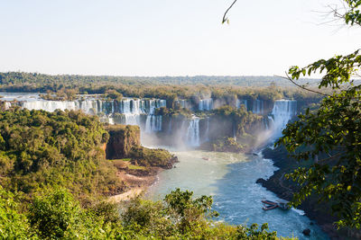 Scenic view of waterfall against clear sky