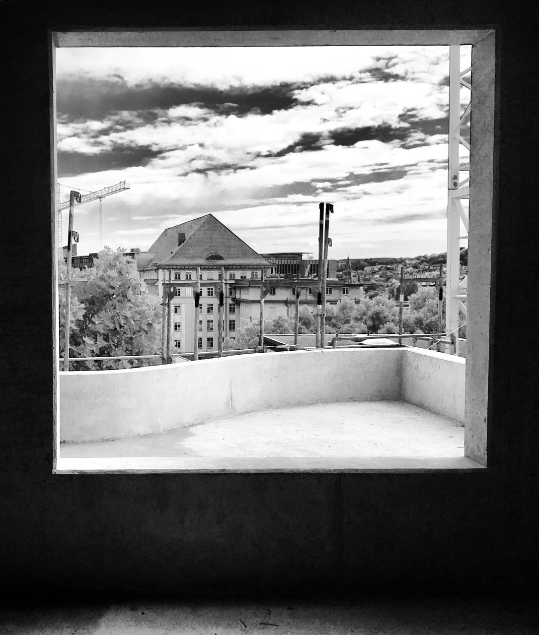 BUILDING AGAINST SKY SEEN THROUGH WINDOW