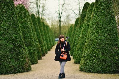 Full length of beautiful woman standing in public park