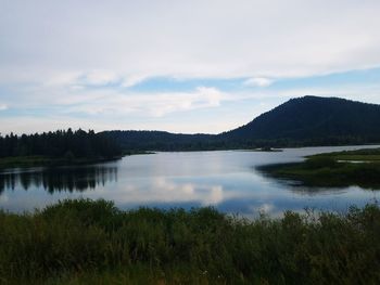 Scenic view of lake and mountains against sky