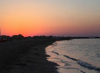 Scenic view of beach against sky during sunset