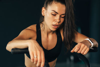 Young woman exercising at gym