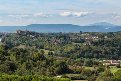 Scenic view of trees and buildings against sky