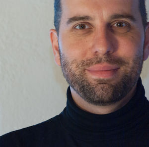 Close-up portrait of man against wall