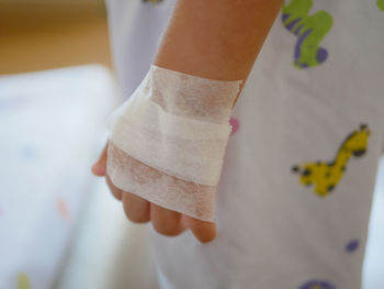 Close-up of woman with bandage on hand