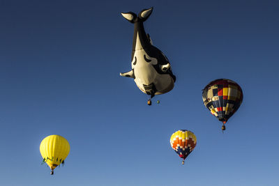 Low angle view of hot air balloon against clear blue sky